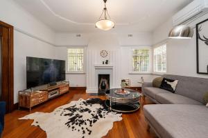 a living room with a couch and a table at Deco Days - Prahran in Melbourne
