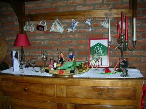 a table with wine glasses and christmas ornaments on it at La Chrysalide in Mons