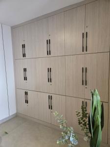a row of wooden cabinets in a room at Sky homes ogbojo in Ogbojo +13 photos