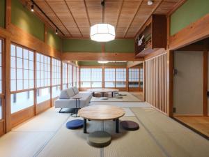 a living room with a table and chairs and windows at Enza - Vacation STAY 69573v in Katori
