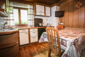 a small kitchen with a table and a sink at Casa Serac´ in La Valle