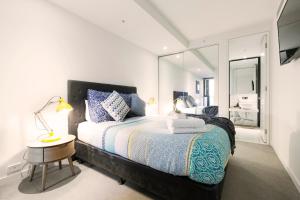 a hotel room with a bed and a desk at Boutique Abode 316 in Melbourne