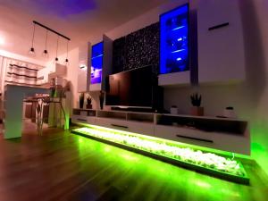 a living room with green lights on the floor at Paloma Blanca 2 in Gárdony