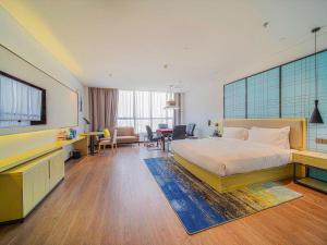 a hotel room with a bed and a television at Echarm Hotel Foshan West Station Shishan Luocun in Foshan +232 photos