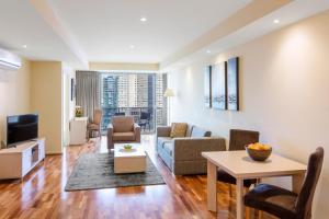 a living room with a couch and a table at Oaks Melbourne on Lonsdale Suites in Melbourne