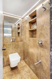 a bathroom with a toilet and a shower at Pebble Studio Bandra W The Bombay Home Company - Eco in Mumbai +9 photos
