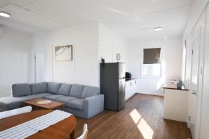 a living room with a couch and a refrigerator at CoastalandCo in Evans Head