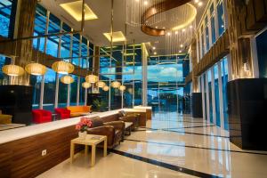 a lobby with couches and chairs in a building at Hotel 88 Kopo Bandung By WH in Bandung