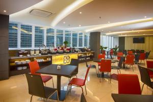 a restaurant with tables and chairs and a bar at Hotel 88 Kopo Bandung By WH in Bandung