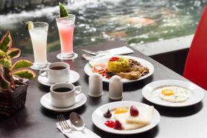 a table with plates of breakfast food and drinks at Hotel 88 Kopo Bandung By WH in Bandung