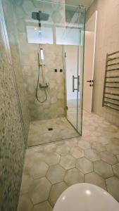 a bathroom with a shower with a glass door at Tranquil Family Retreat in Red Beach