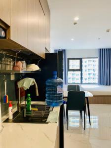 a kitchen with a sink with a bottle of water at Shi House - Studios Building GH6 Near Vincom& Park in Long Bình