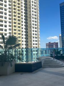a person walking down stairs in a city with tall buildings at Seravé Home in Sampong