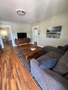 a living room with a couch and a coffee table at Brick Bungalow 1 block to I80 charmingly renovated in Reno