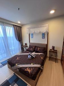 a bedroom with a large bed and a large window at Timurbay Seafront Kuantan Beach D'Sunset Ombak Samudera in Kuantan