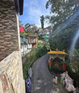 a view of a village with a building on a road at Zambalaas Inn in Darjeeling