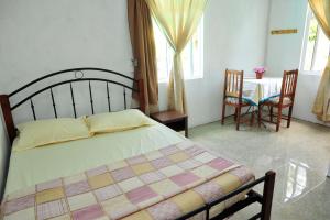 Postel nebo postele na pokoji v ubytování Chez Ronald Guest House