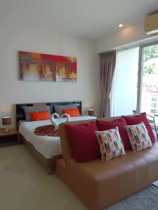 a bedroom with a bed and a couch at A Big Condo in Karon Walking distance to Beach in Karon Beach