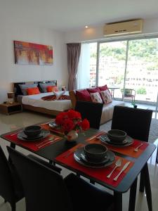 a living room with a table and a couch at A Big Condo in Karon Walking distance to Beach in Karon Beach