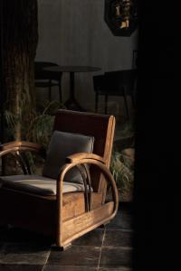 a wooden chair sitting in a room with a table at Huangshan Chenkan Su House Hotel in Chengkan +26 photos