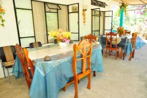 een eetkamer met blauwe tafels en stoelen bij Chez Ronald Guest House in Rodrigues Island