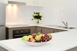 a bowl of fruit on a counter in a kitchen at Oaks Middlemount Suites in Middlemount