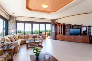 A television and/or entertainment centre at Villa Antikleia
