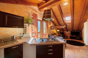 a kitchen with a stove and a living room at Anita Haus - Issime in Issime