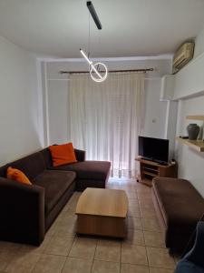 a living room with a couch and a tv at KT Apartment in Drama