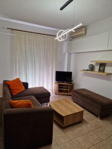a living room with a couch and a coffee table at KT Apartment in Drama