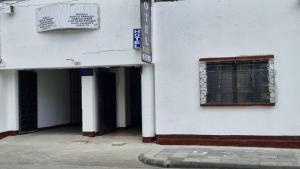 an entrance to a white building with a window at Hotel Modelo in Estación La Ermita