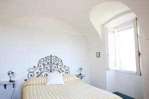 En eller flere senge i et værelse på Terre Bianche Appartamenti