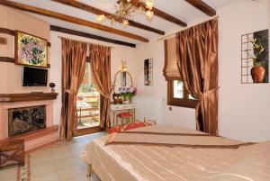 a bedroom with a bed and a fireplace at Nikolaou House in Tsagarada