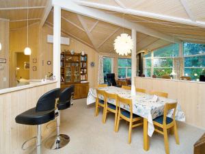 a dining room with a table and chairs at 5 star holiday home in Græsted in Udsholt Sand +31 photos