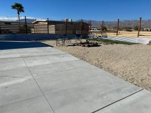 a sidewalk with tables and chairs in front of a building at Ranch Property on 2 acres! in Desert Hot Springs