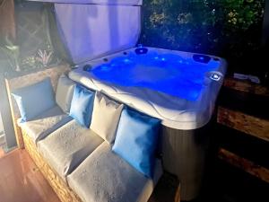 a jacuzzi tub in an aquarium with pillows at O CANTINHO DA RIA - JACUZZI with water at 35 degrees and POOL in Torreira