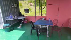 a table and chairs in a room with a window at Bekbek's Village in Kangar