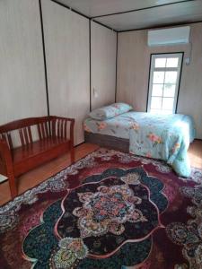 a bedroom with a bed and a rug on the floor at Bekbek's Village in Kangar +9 photos