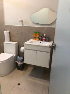 a bathroom with a white sink and a toilet at Casa de Campo La Martina con piscina y parrilla in Tambo de Mora