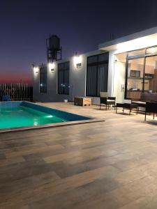a house with a swimming pool at night at Casa de Campo La Martina con piscina y parrilla in Tambo de Mora