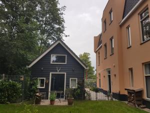 una casa nera in un cortile tra due edifici di Cozy Cottage a Utrecht