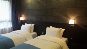 Voodi või voodid majutusasutuse S Stay Dongtan Hotel toas