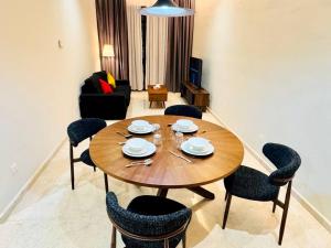 a living room with a wooden table and chairs at TM Persiaran Stonor BY PANORAMA in Kuala Lumpur