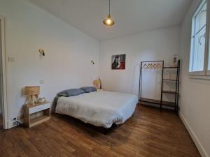 a bedroom with a large bed and a window at Maison de ville proche de tous les commerces in Égletons