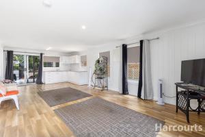 a living room with white walls and a flat screen tv at KS Maryborough 2-Bedroom Apartment in Maryborough