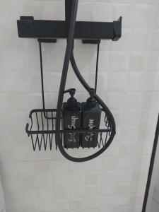 a black hanging basket with two bottles in it at Ático acogedor, céntrico y a 2 min de la playa. in Fuengirola