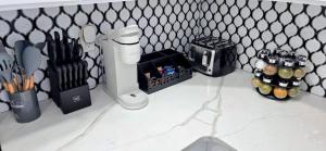 a kitchen counter with utensils and a knife block at Newly Renovated 2B 2BA apt! mins to PATH & NY! in Jersey City