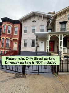 a sign on a fence in front of a house at Newly Renovated 2B 2BA apt! mins to PATH & NY! in Jersey City