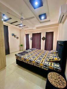 a bedroom with a bed and two chairs in it at Sk property in Islamabad