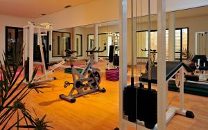 a gym with treadmills and exercise bikes in a room at Vincci Safira Palms in Sangho
